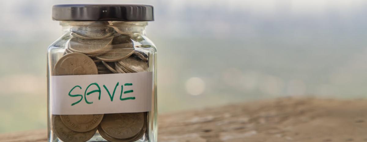 A jar of coins with a label on it that says 'save'.